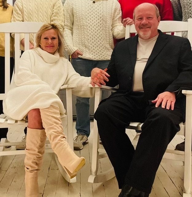 Pat Sebesta Law Firm - A group of people posing in white rocking chairs at home.